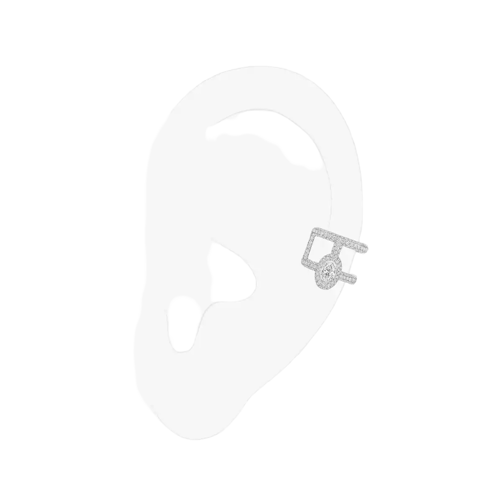Clip d'oreille Divine Enigma Boucle d'oreille clip Divine Enigma en or blanc 18 carats, sertie d'un diamant taille ovale et de diamants taille brillant. Pour oreille gauche.
